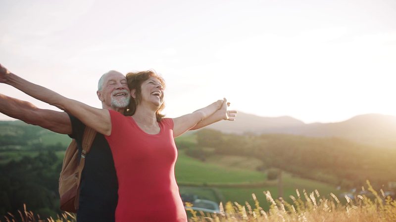 A smiling couple enjoying a hilltop view (illustrative photo)